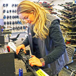 An employee adjusting rental skis at Massanutten Resort