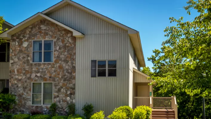 Exterior photo of Woodstone Meadows condo building